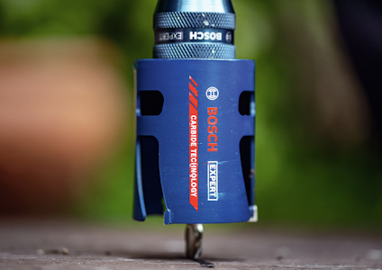 Blå Borhålssåg med Bosch-logotyp och texten "Carbide Technology Expert". Skärhuvud synligt på träyta i fokus.