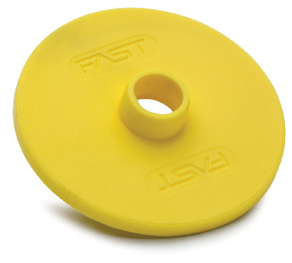 Gul rund plastbricka med upphöjd kant och texten "FAST" på båda sidor om det centrala hålet.